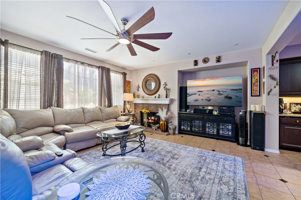 29009 Smooth Sailing Court Menifee, CA 92585 - Photo 21 of 62 a living room with furniture a large window and a flat screen tv