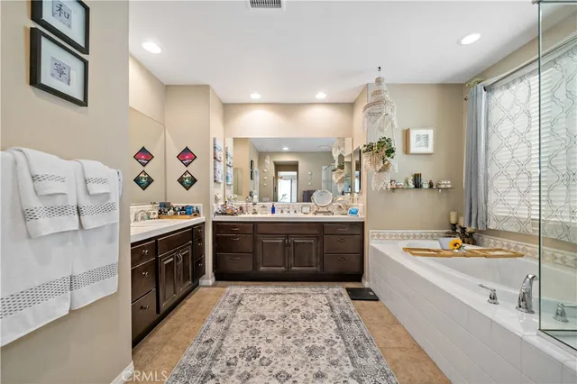 a spacious bathroom with a double vanity sink and mirror