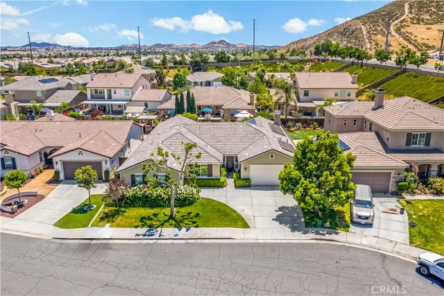 an aerial view of multiple houses with a yard