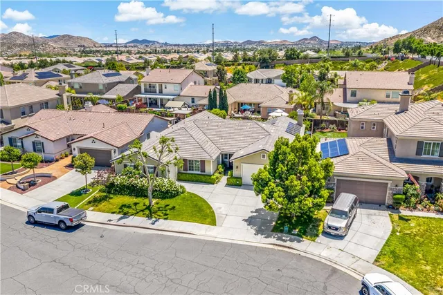 front view of a brick house with a yard