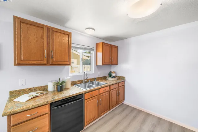 a kitchen with stainless steel appliances granite countertop a sink stove and cabinets