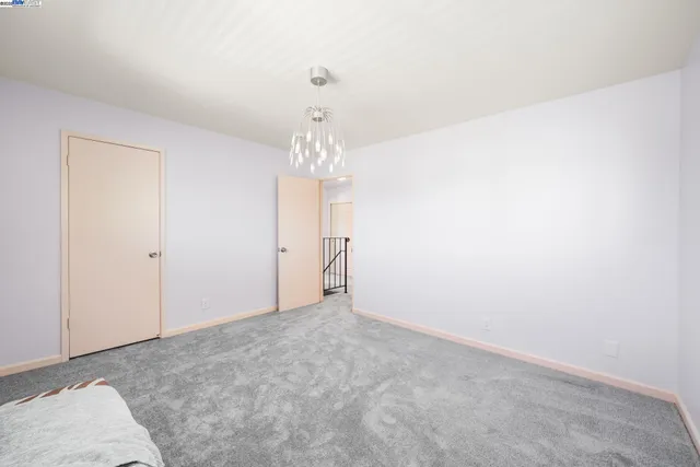 a bedroom with a bed and a potted plant