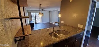 a bathroom with a granite countertop sink a toilet and a mirror