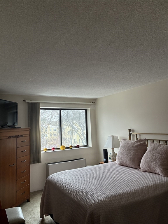 1 Summit Drive, Unit 57 Reading, MA 01867 - Photo 12 of 18 a bedroom with a large bed and a large window