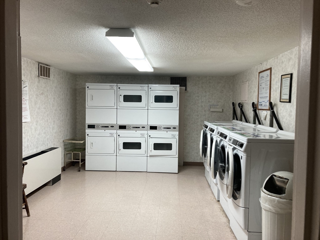 1 Summit Drive, Unit 57 Reading, MA 01867 - Photo 16 of 18 a utility room with dryer and washer