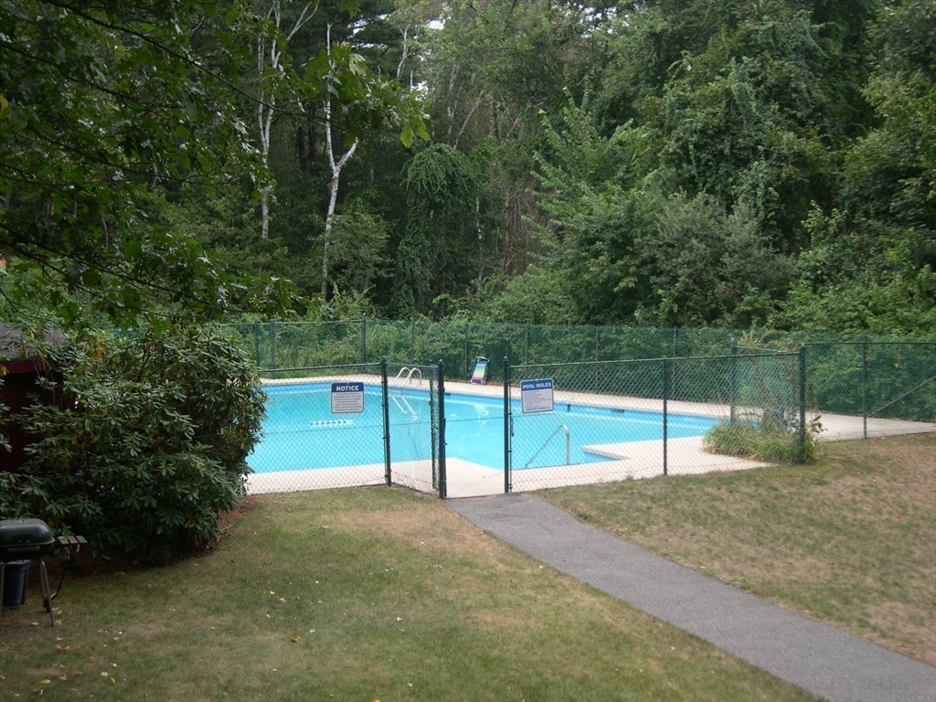 1 Summit Drive, Unit 57 Reading, MA 01867 - Photo 18 of 18 a view of a tennis ground with large trees
