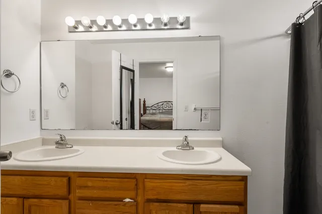 a bathroom with a sink double vanity and a mirror