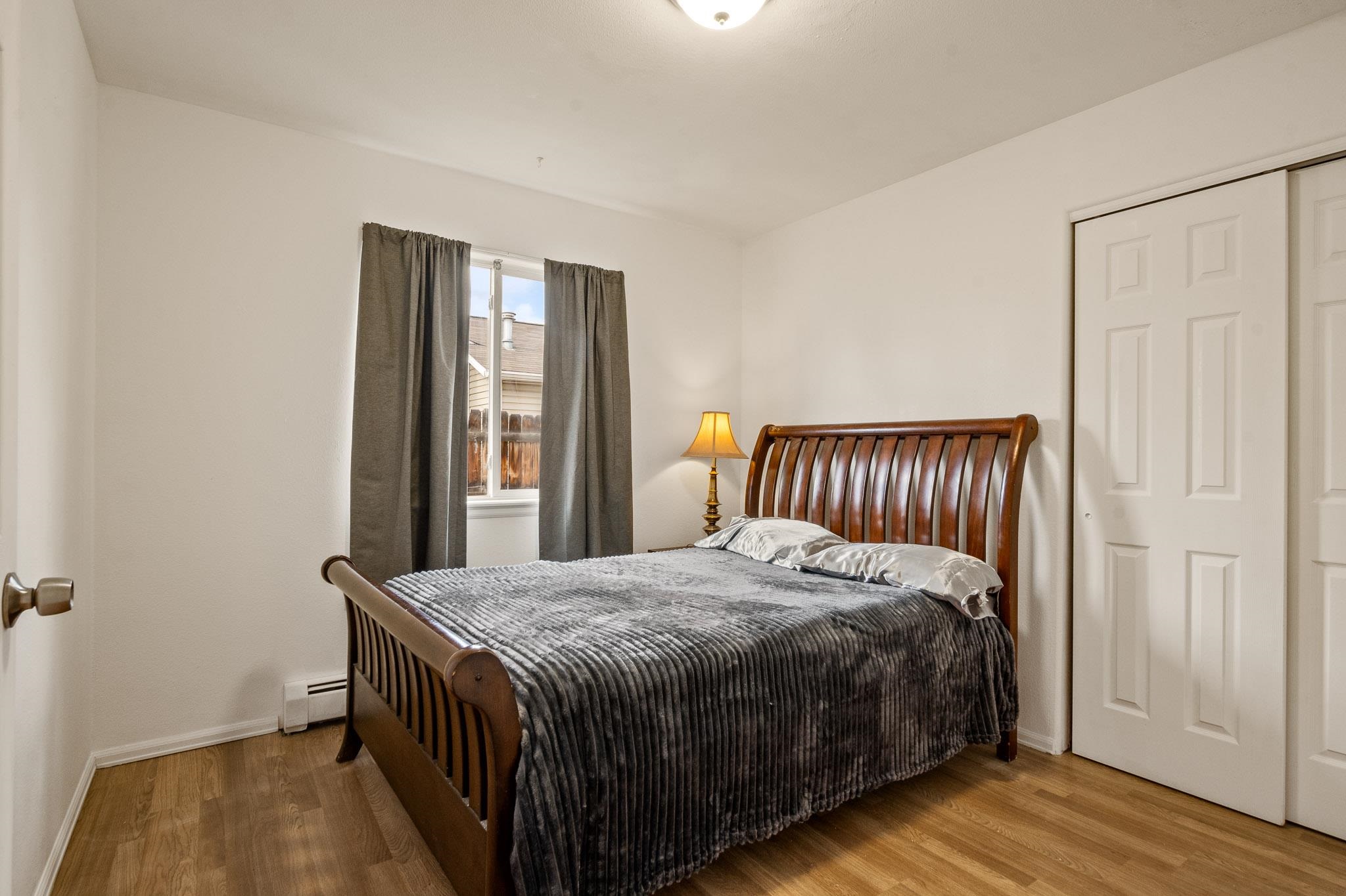 1456 Sagittarius Street Fruita, CO 81521 - Photo 13 of 19 a bedroom with a bed and wooden floor