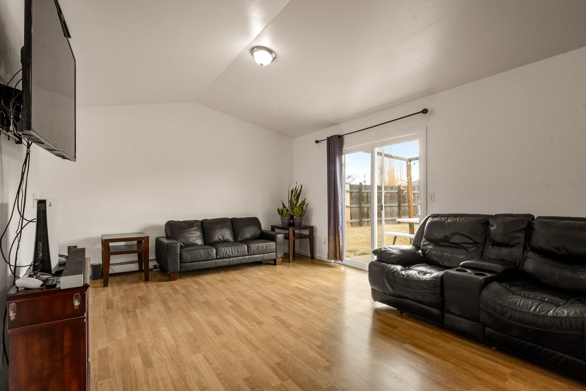 1456 Sagittarius Street Fruita, CO 81521 - Photo 3 of 19 a living room with furniture and a flat screen tv