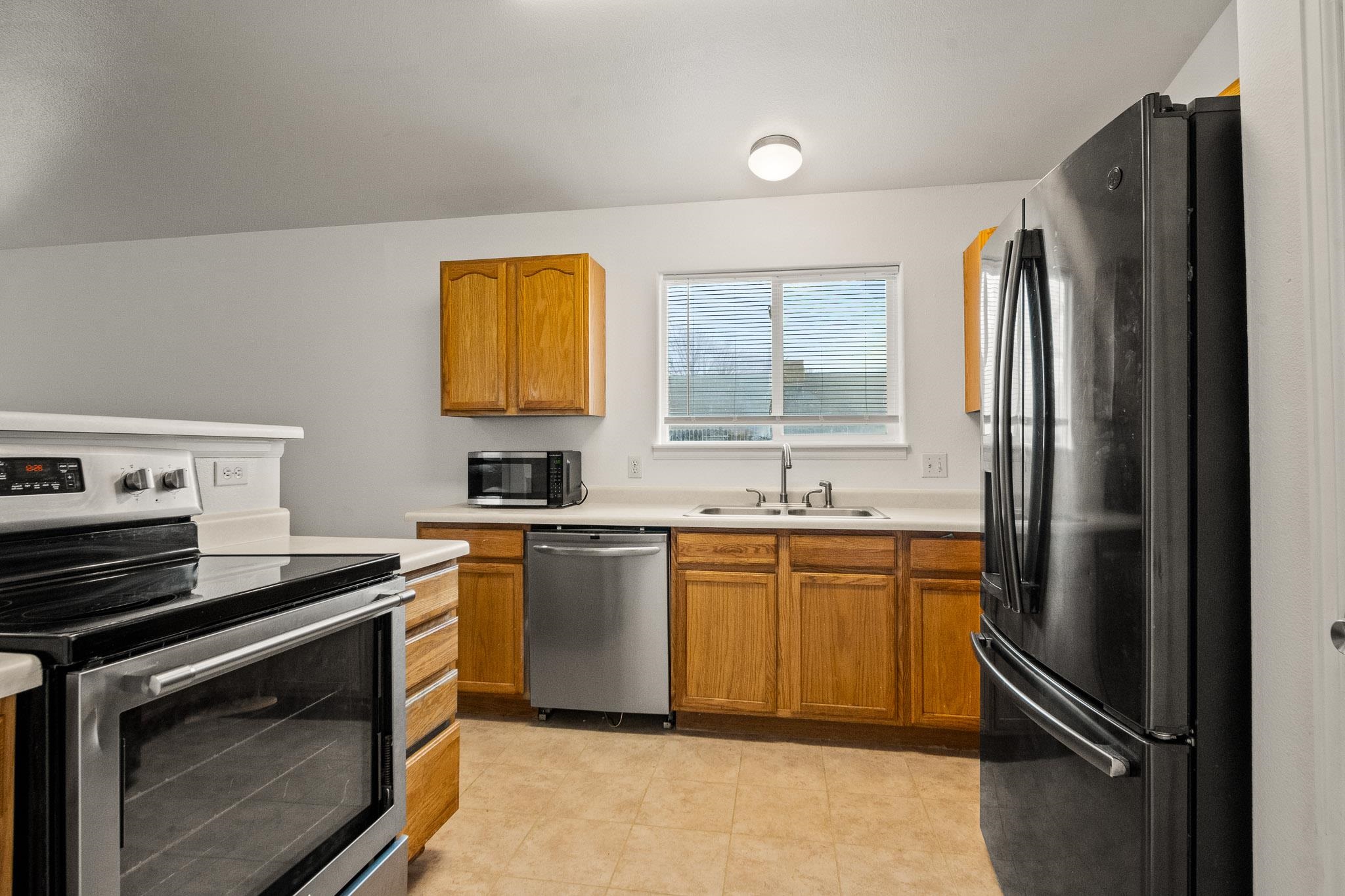 1456 Sagittarius Street Fruita, CO 81521 - Photo 7 of 19 a kitchen with stainless steel appliances granite countertop a refrigerator and a sink