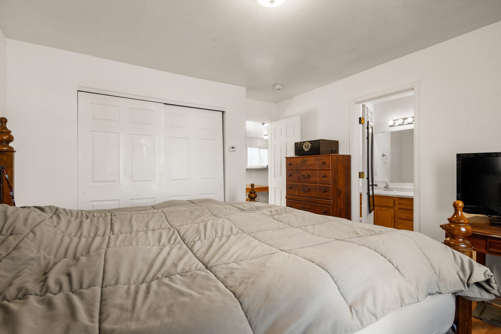 1456 Sagittarius Street Fruita, CO 81521 - Photo 9 of 19 a bedroom with a bed and a flat screen tv