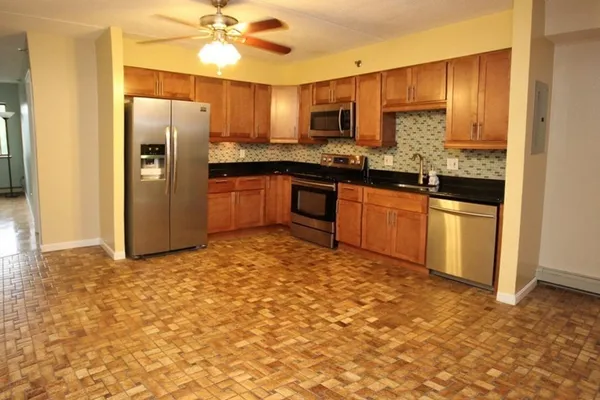 a kitchen with stainless steel appliances granite countertop a refrigerator stove and sink