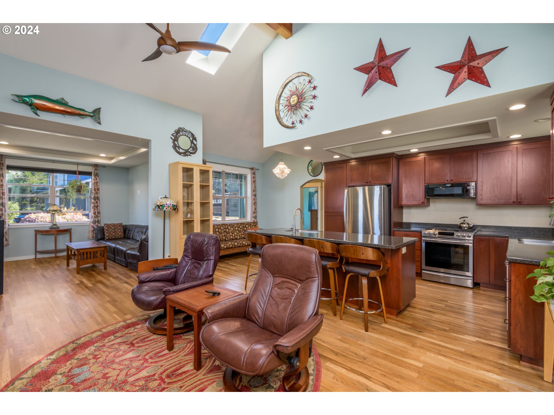 490 Lemwick Lane Yachats, OR 97498 - Photo 13 of 42 a living room with furniture kitchen view and a wooden floor