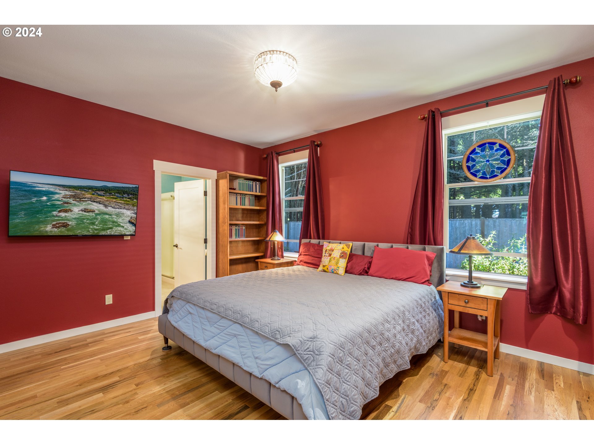 490 Lemwick Lane Yachats, OR 97498 - Photo 21 of 42 a bedroom with a bed and a flat screen tv