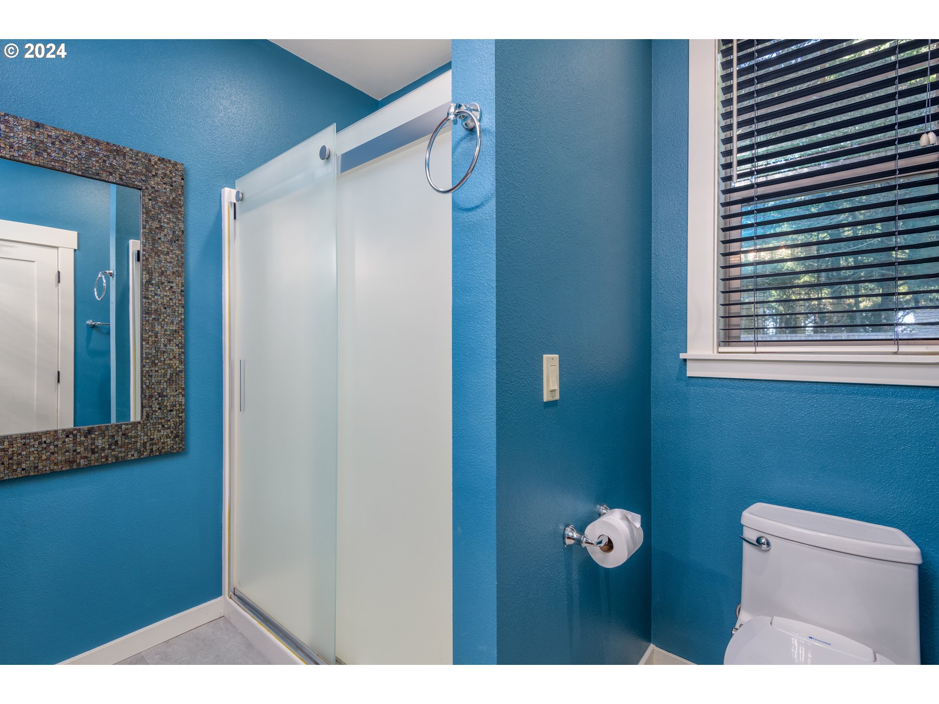 490 Lemwick Lane Yachats, OR 97498 - Photo 27 of 42 a bathroom with a toilet sink and mirror