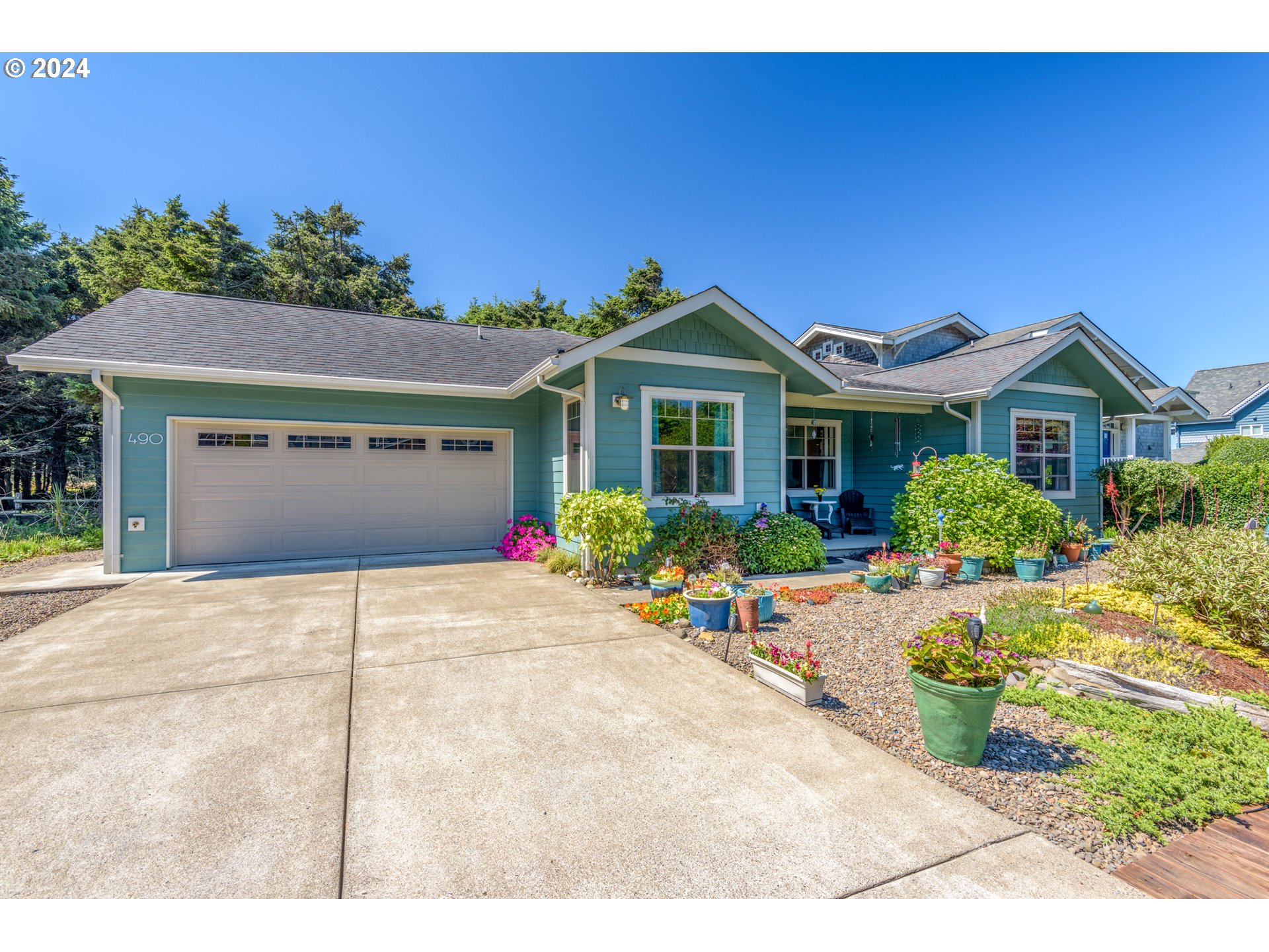 490 Lemwick Lane Yachats, OR 97498 - Photo 38 of 42 a front view of a house with a garage