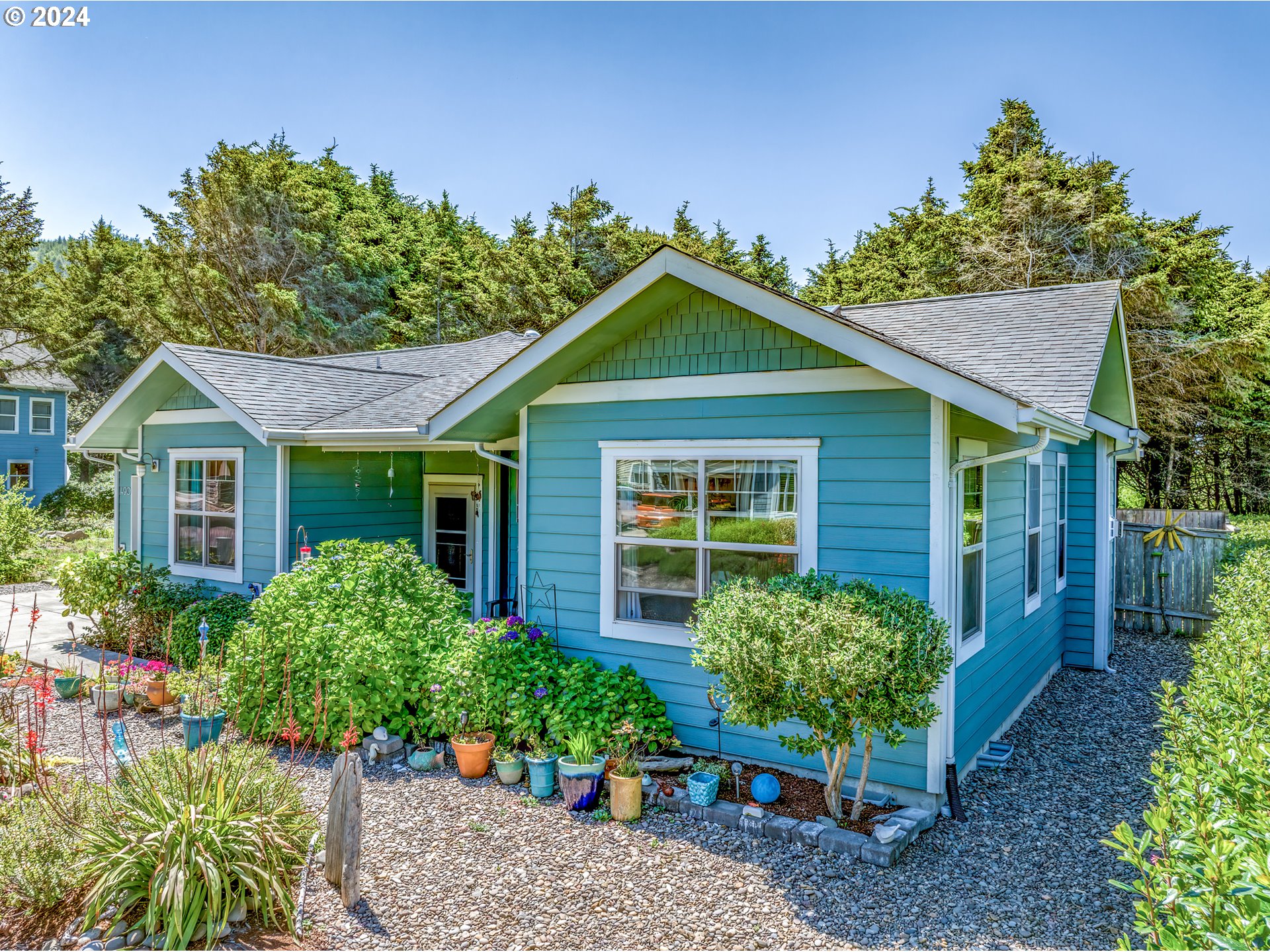 490 Lemwick Lane Yachats, OR 97498 - Photo 39 of 42 a front view of a house with a yard