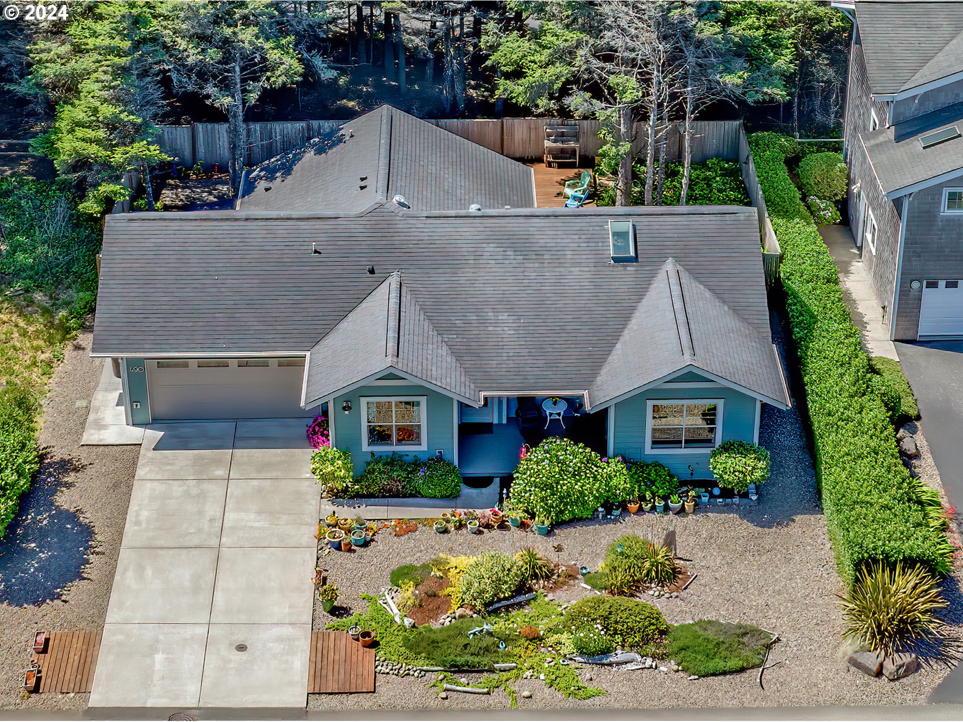 490 Lemwick Lane Yachats, OR 97498 - Photo 4 of 42 an aerial view of a house with a yard and potted plants