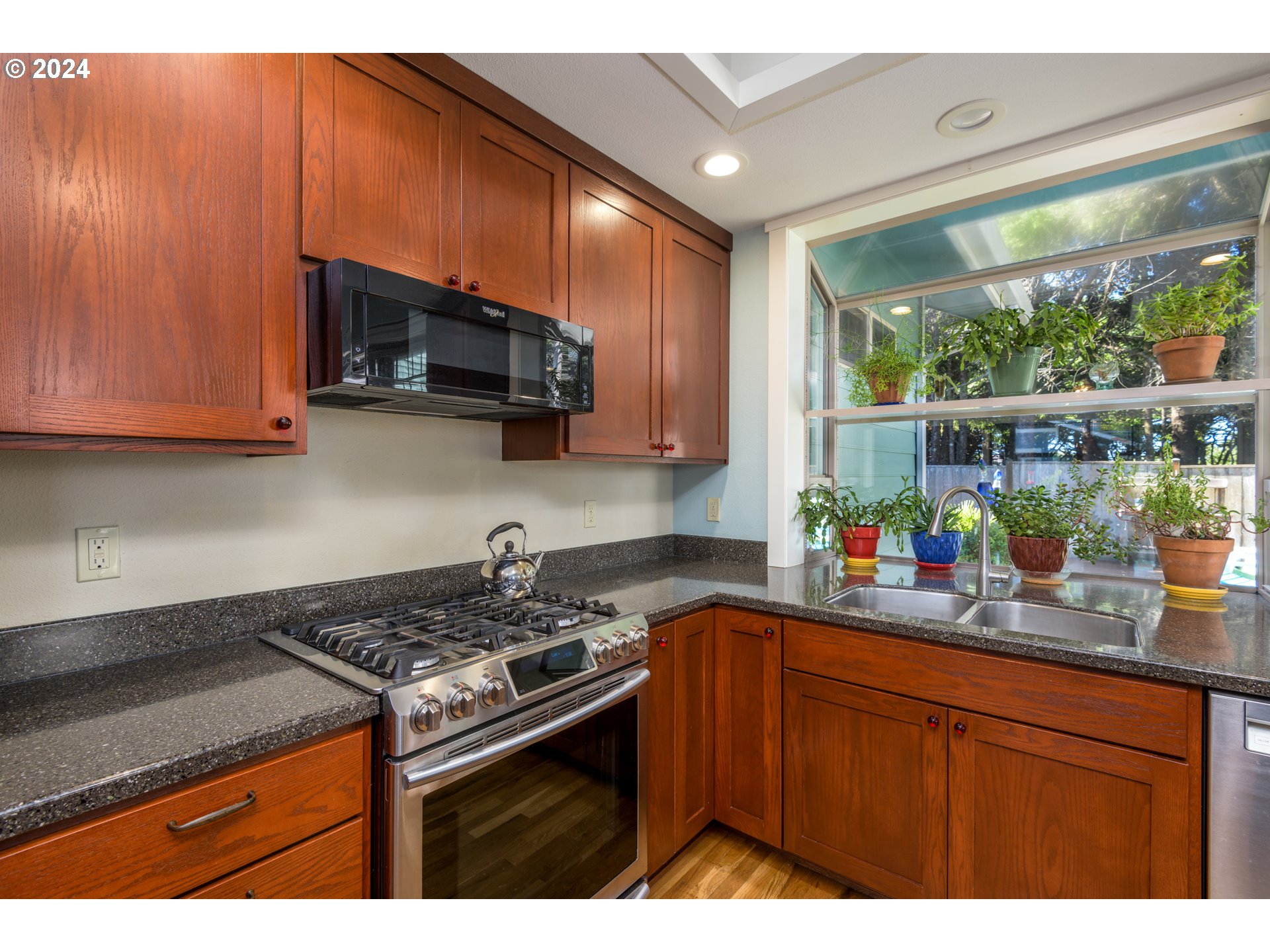 490 Lemwick Lane Yachats, OR 97498 - Photo 10 of 42 a kitchen with stainless steel appliances granite countertop a stove a sink and a microwave