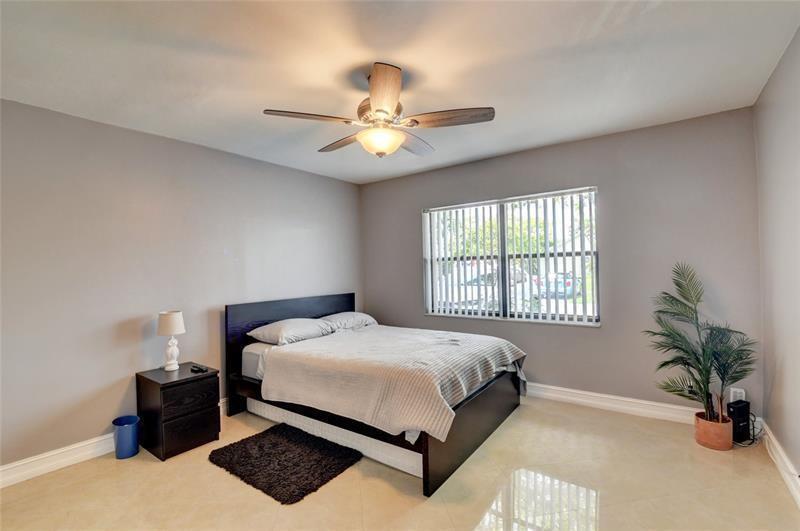 9316 Ketay Circle Boca Raton, FL 33428 - Photo 6 of 30 a bedroom with a bed lamp and a chandelier