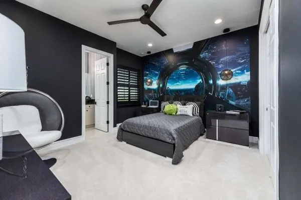 a bedroom with furniture and a large window