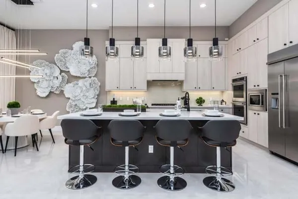a kitchen with a dining table chairs sink and kitchen view