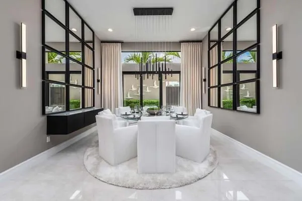 a living room with large windows and furniture