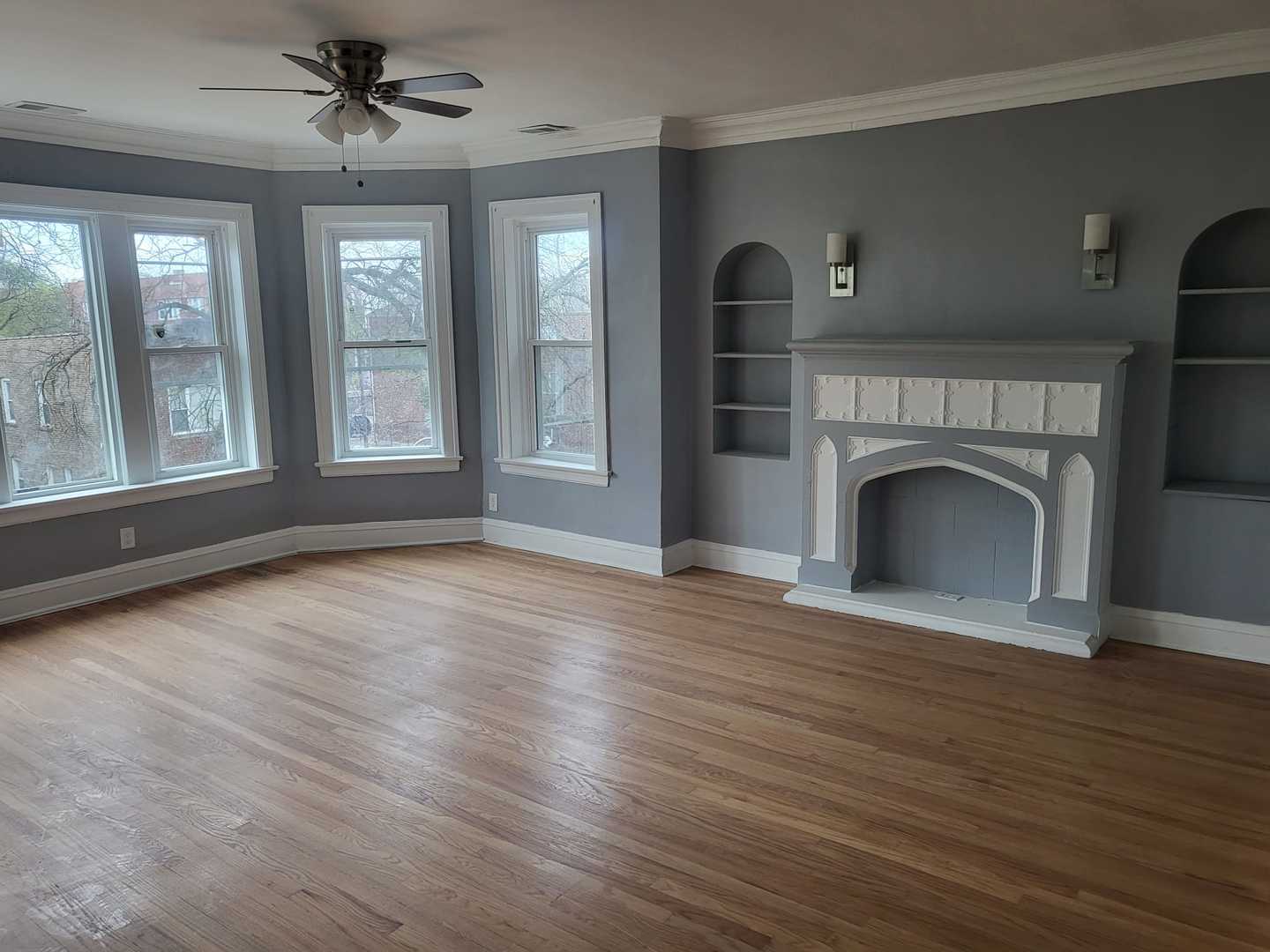 7307 South Bennett Avenue, Unit 1 Chicago, IL 60649 - Photo 2 of 9 a view of empty room with fireplace and wooden floor