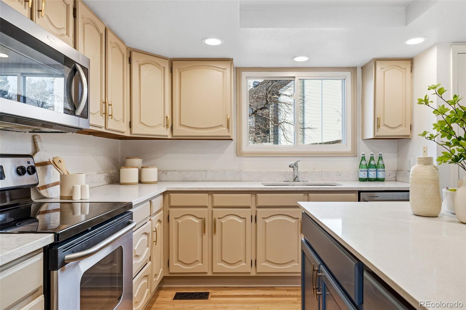 9426 Princeton Circle Highlands Ranch, CO 80130 - Photo 11 of 50 a kitchen with stainless steel appliances granite countertop a sink a stove cabinets and a window