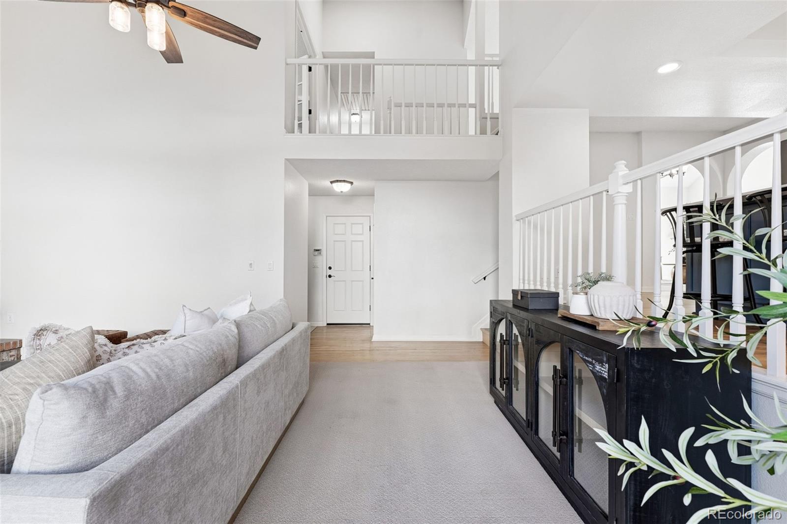 9426 Princeton Circle Highlands Ranch, CO 80130 - Photo 18 of 50 a living room with furniture a fireplace and a projector
