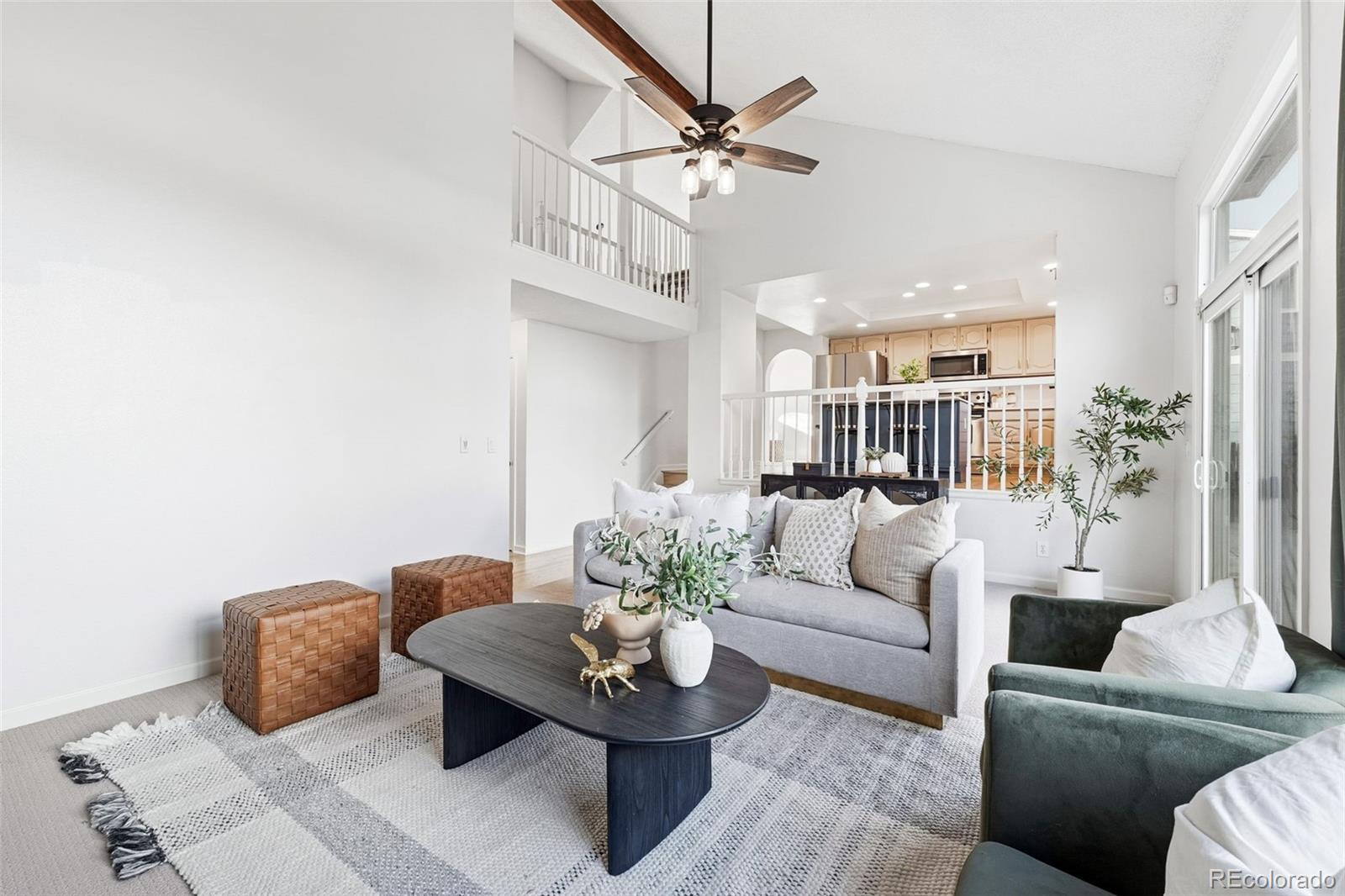 9426 Princeton Circle Highlands Ranch, CO 80130 - Photo 22 of 50 a living room with furniture and a chandelier