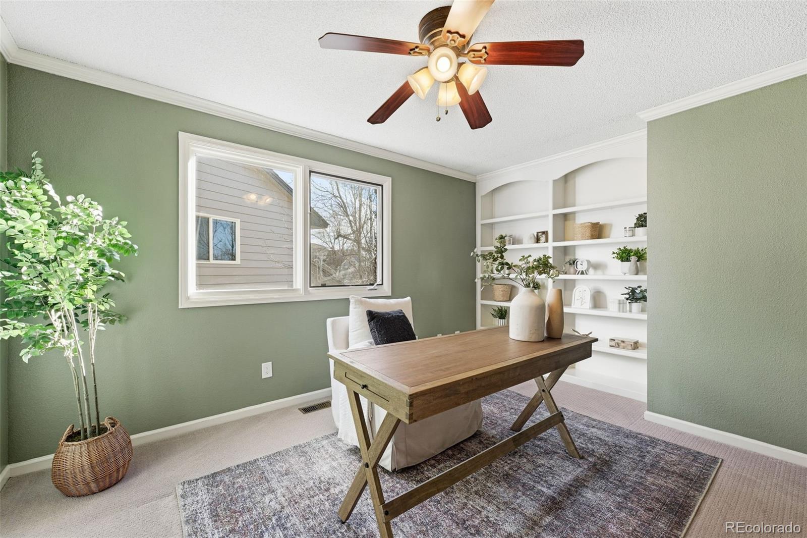 9426 Princeton Circle Highlands Ranch, CO 80130 - Photo 33 of 50 a living room with furniture and a potted plant