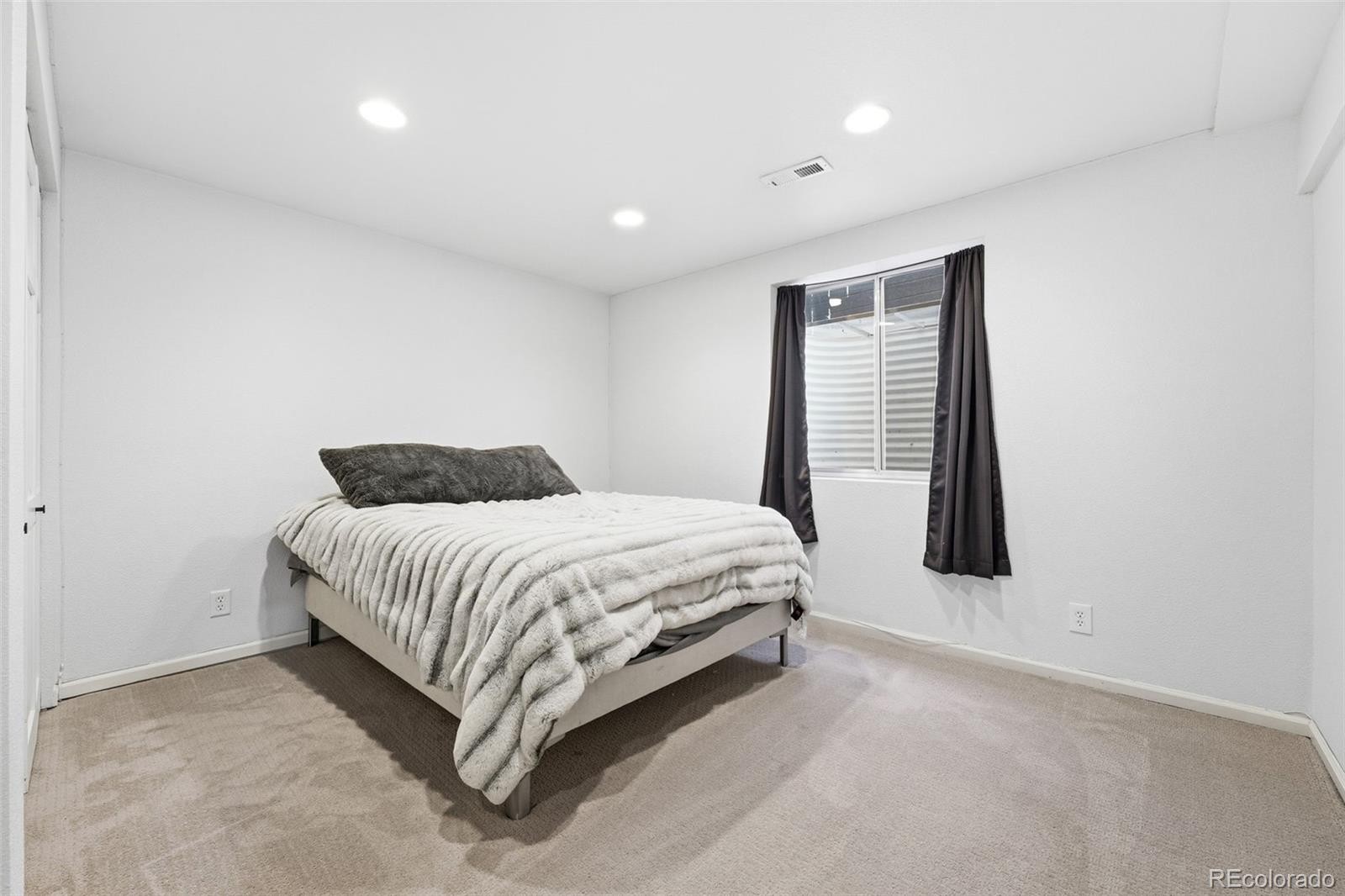 9426 Princeton Circle Highlands Ranch, CO 80130 - Photo 42 of 50 a spacious bedroom with a bed and a window