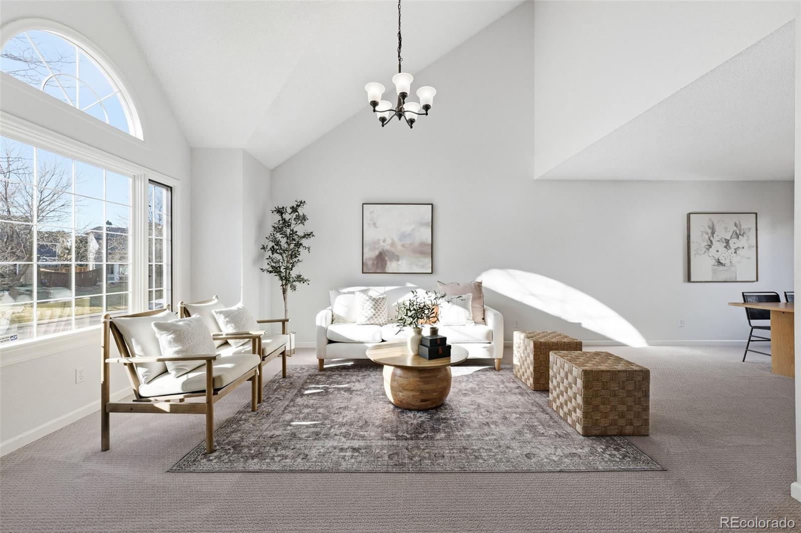 9426 Princeton Circle Highlands Ranch, CO 80130 - Photo 5 of 50 a living room with furniture and a chandelier