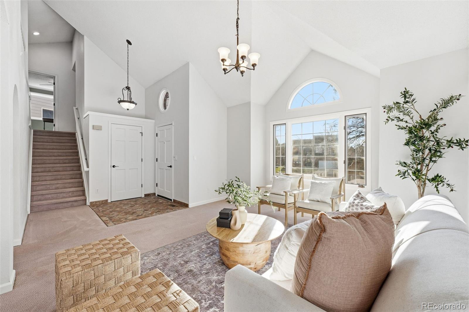 9426 Princeton Circle Highlands Ranch, CO 80130 - Photo 7 of 50 a living room with furniture and a chandelier