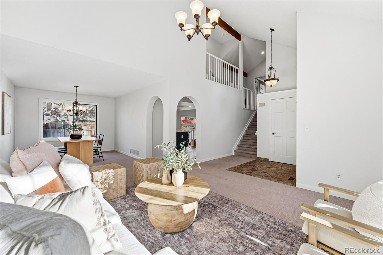 9426 Princeton Circle Highlands Ranch, CO 80130 - Photo 8 of 50 a living room with furniture and a chandelier