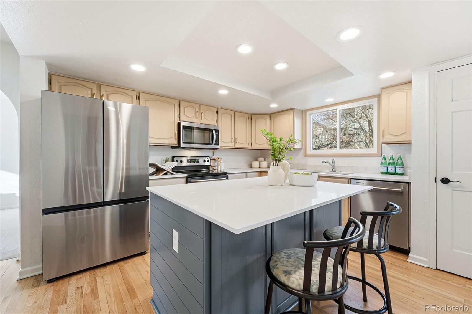 9426 Princeton Circle Highlands Ranch, CO 80130 - Photo 10 of 50 a kitchen with a table chairs refrigerator and microwave