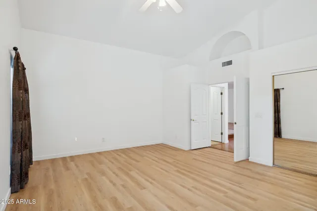 a view of empty room with wooden floor