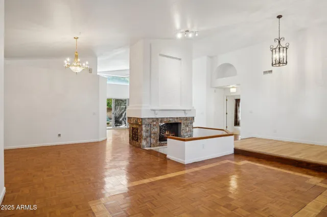 a living room with a bed furniture and a chandelier