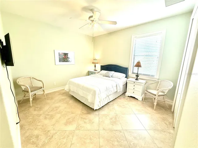 a bedroom with a bed and a chair