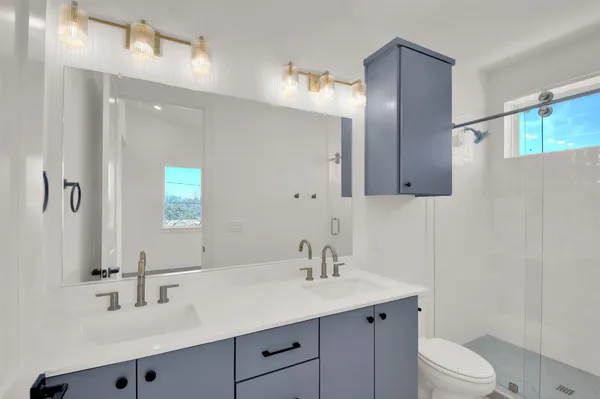 a view of a kitchen with white cabinets