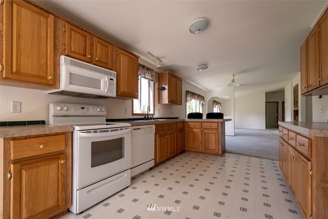 322 O Brien Road Port Angeles, WA 98362 - Photo 12 of 37 a kitchen with stainless steel appliances granite countertop a stove and a sink