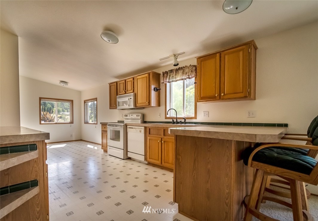 322 O Brien Road Port Angeles, WA 98362 - Photo 13 of 37 a kitchen with stainless steel appliances a stove sink and cabinets