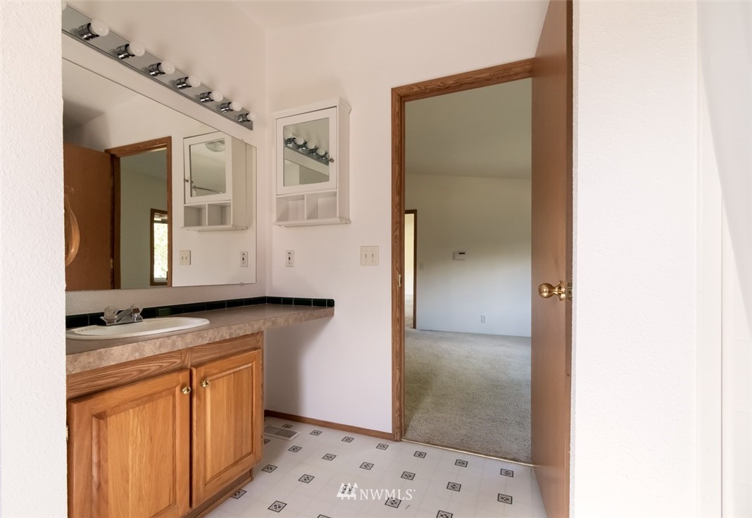 322 O Brien Road Port Angeles, WA 98362 - Photo 17 of 37 a bathroom with a granite countertop sink and a mirror
