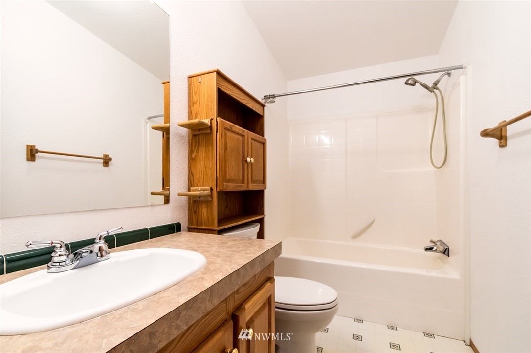 322 O Brien Road Port Angeles, WA 98362 - Photo 20 of 37 a bathroom with a granite countertop sink mirror toilet and bathtub