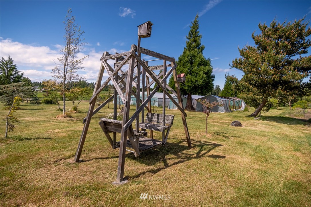 322 O Brien Road Port Angeles, WA 98362 - Photo 25 of 37 a view of a swimming pool with a bench and trees
