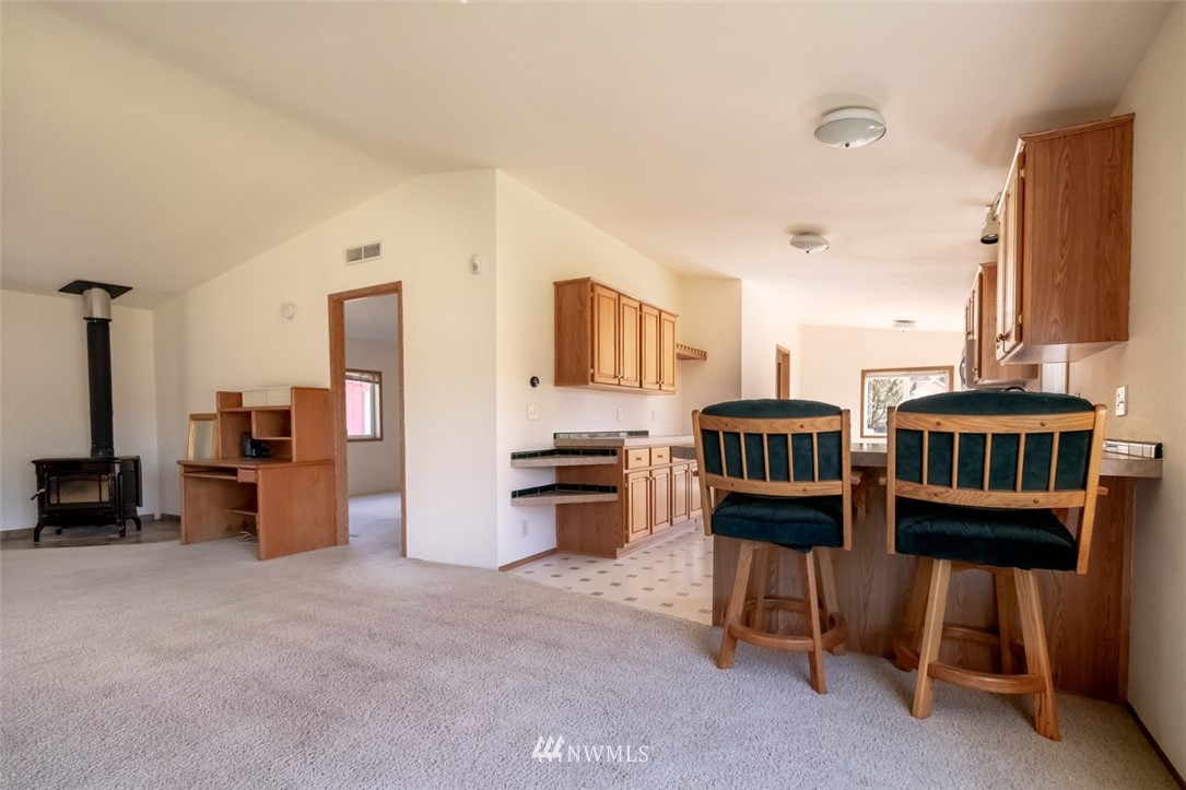 322 O Brien Road Port Angeles, WA 98362 - Photo 9 of 37 a kitchen with stainless steel appliances kitchen island granite countertop a table and chairs in it