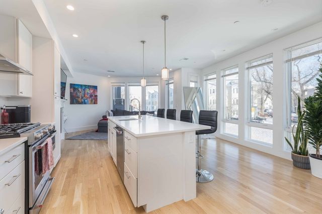 a kitchen with counter top space and wooden floor
