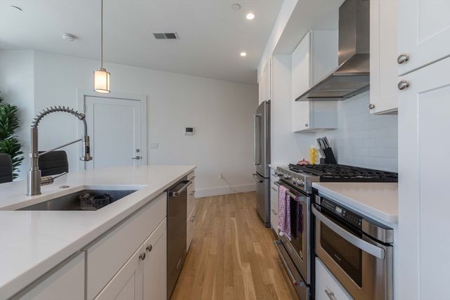 a kitchen that has a sink and a stove