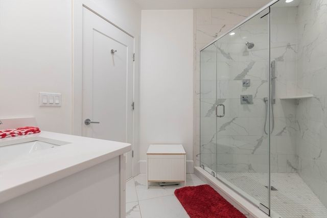 a bathroom with a shower and a sink